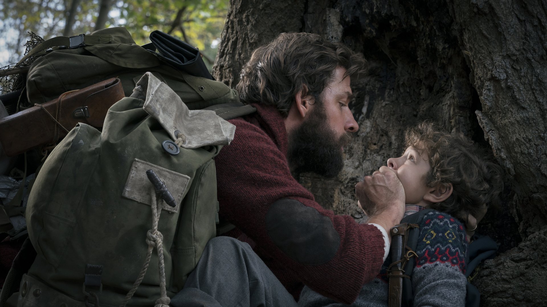 Lee (John Krasinski) holding his hand over his son's (Noah Jupe) mouth in 'A Quiet Place;' How To Create the Suspension of Disbelief in Your Screenplay