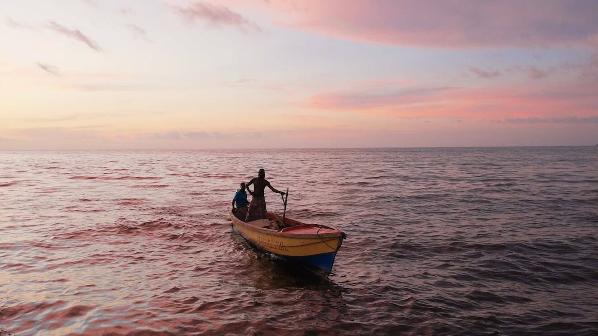 Two people in a boat on the ocean in 'Black Mother,' How To Create Memorable Characters for Your Short Story