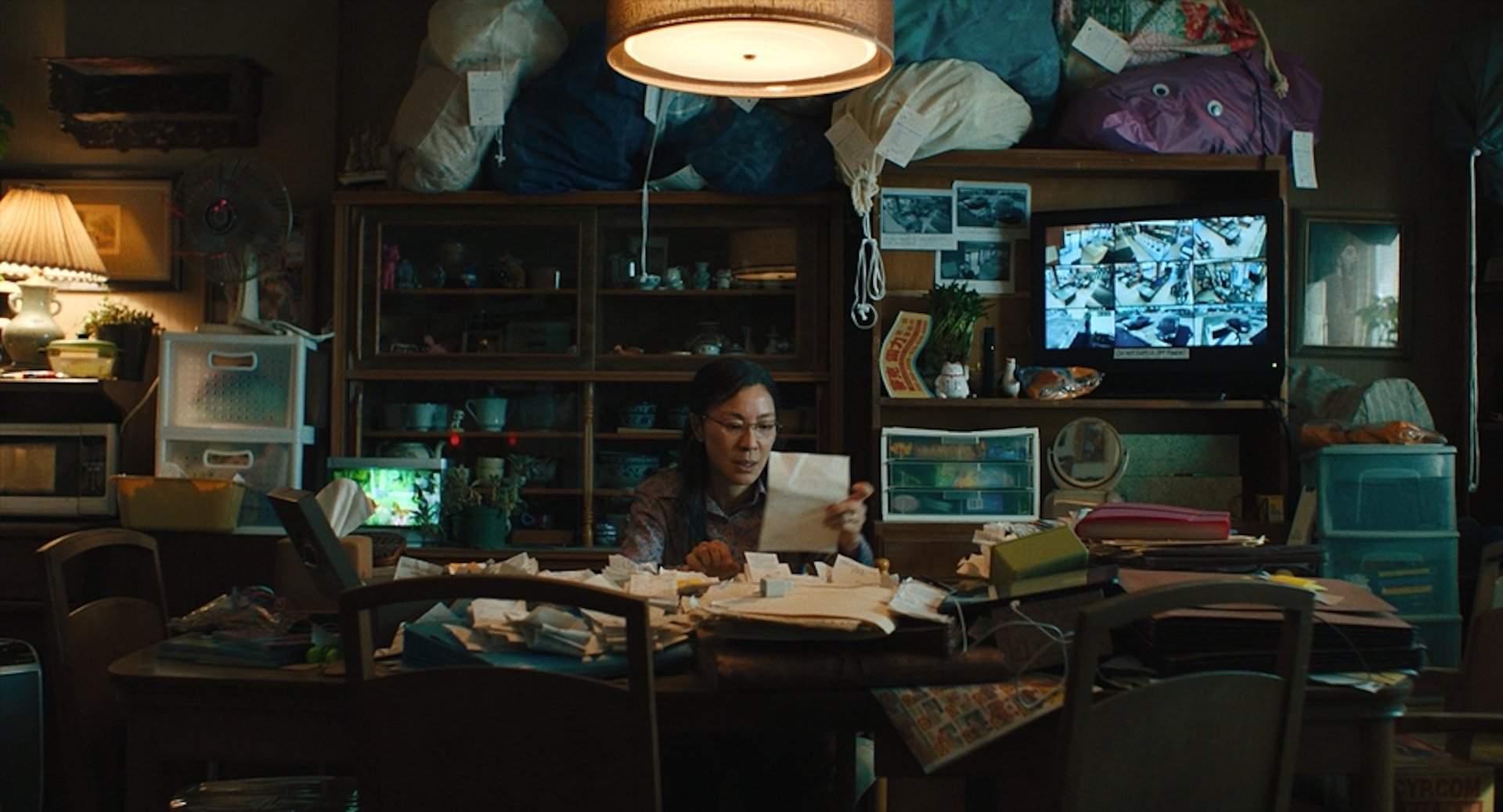 A woman reading a piece of paper in 'Everything Everywhere All at Once'