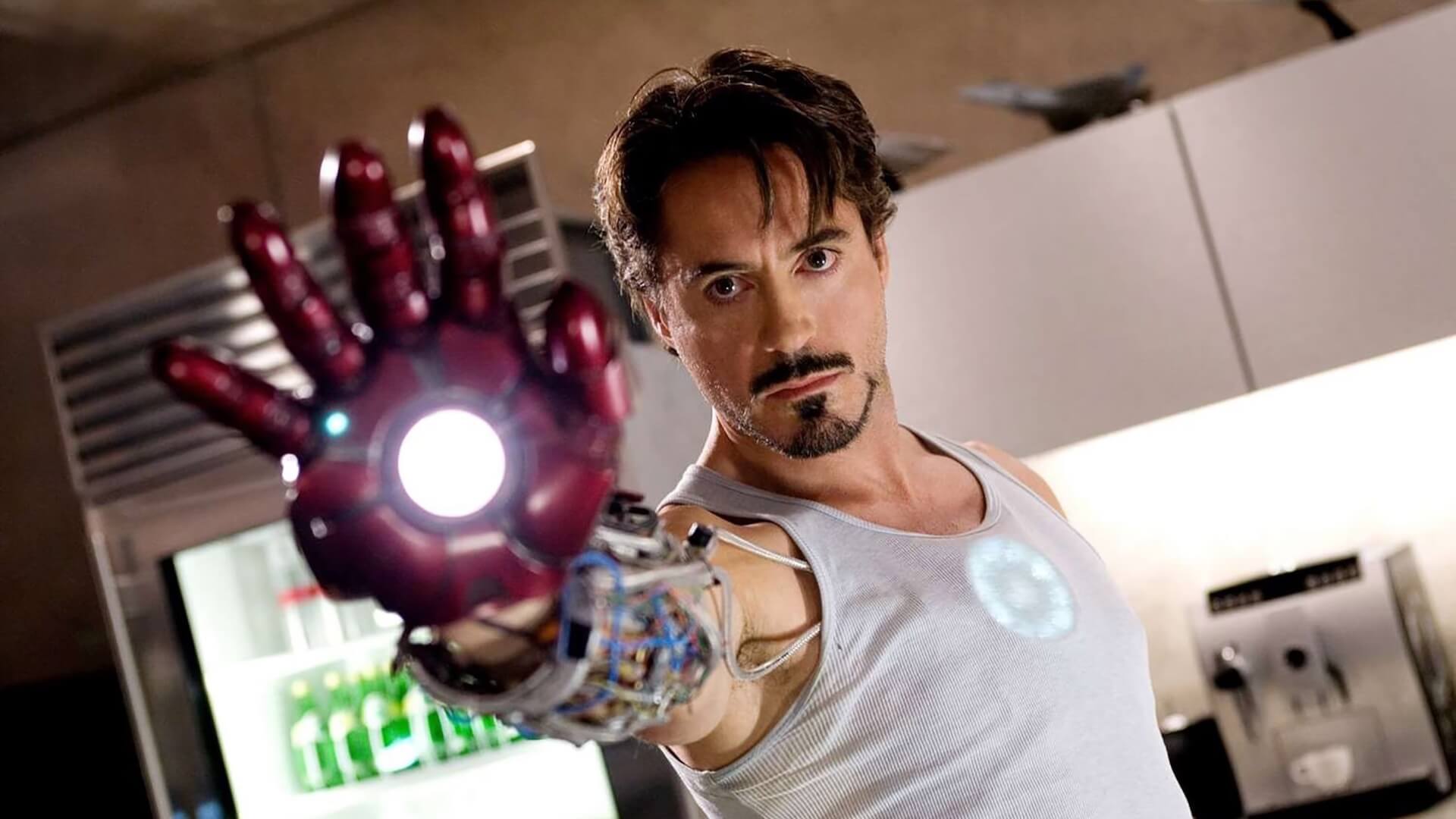 Tony Stark (Robert Downey Jr.) holding out his arm with a piece of the Iron Man suit on in 'Iron Man'