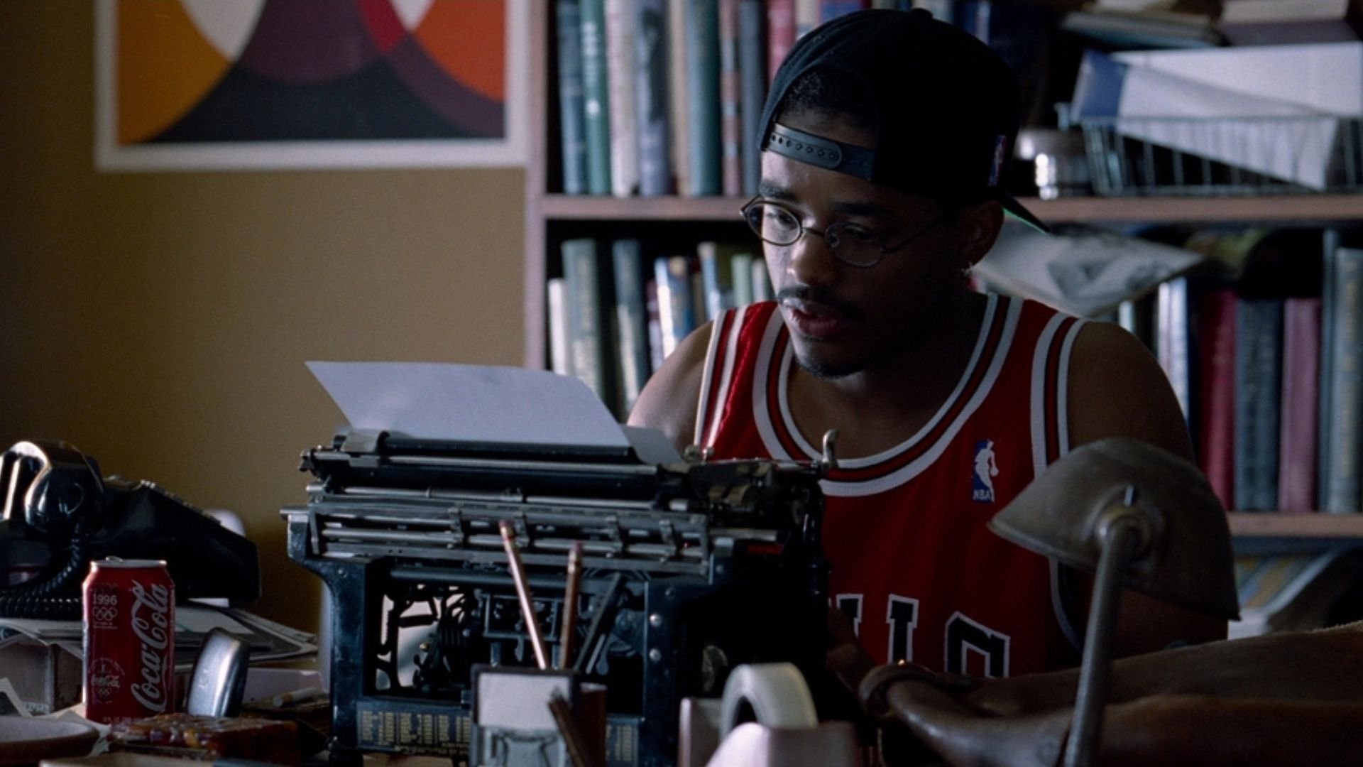 A man in a jersey typing on a typewriter in 'Love Jones,' The Type Stuff: The Benefits of Writing on a Typewriter