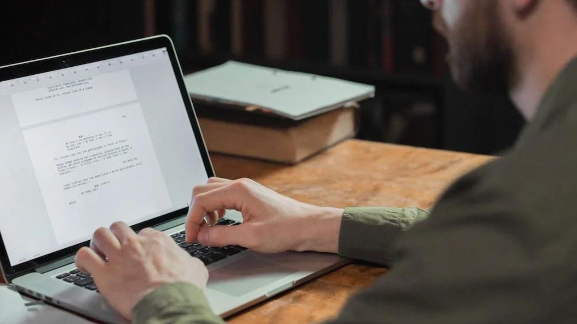 Man Typing on Laptop, Keeping Track of Your Screenwriting Productivity