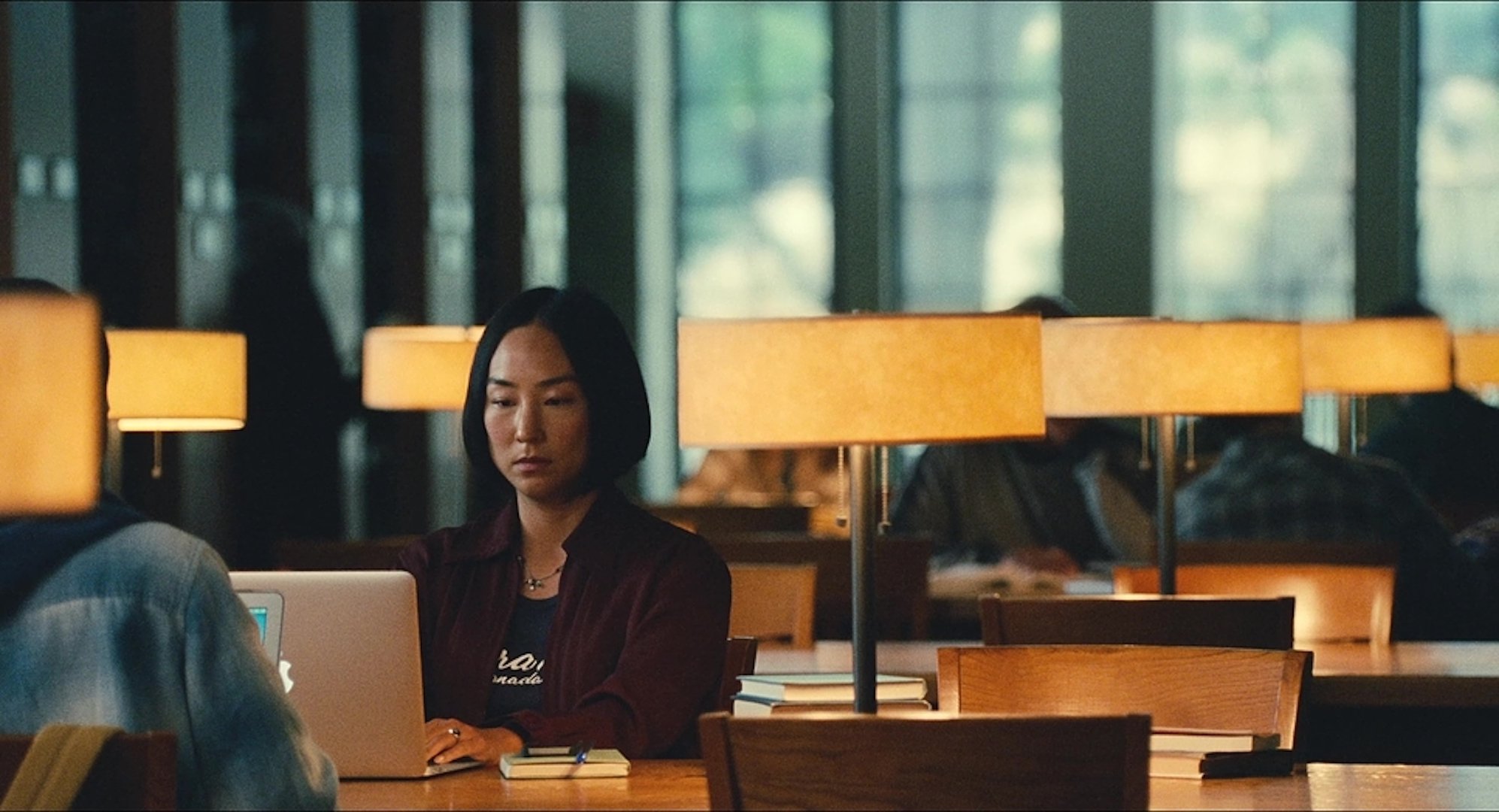 Nora Moon (Greta Lee) typing on a laptop in 'Past Lives' (2023)