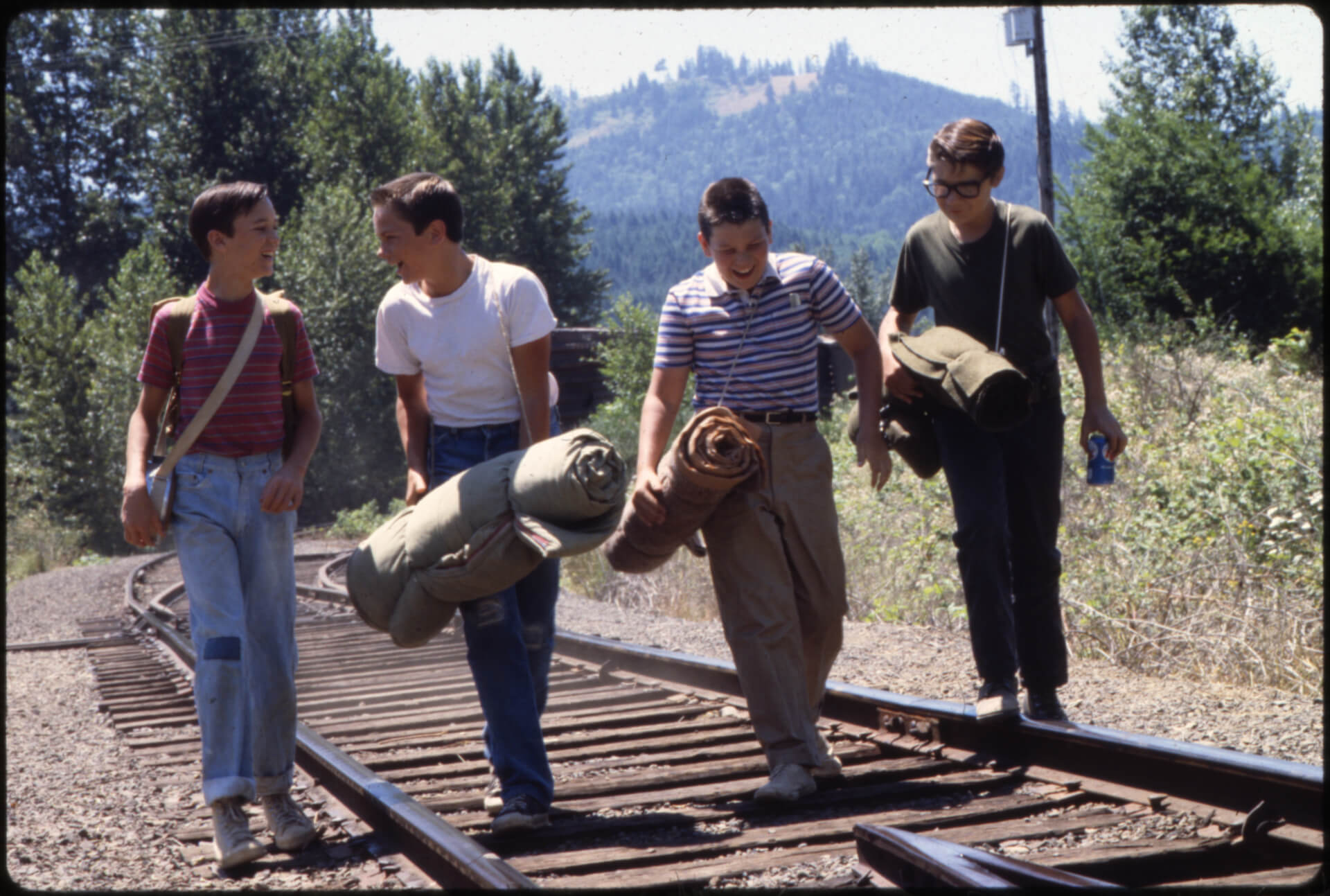 Four boys walking down a railroad in 'Stand by Me,' How to Write a Short Story: 7 Elements to Always Remember