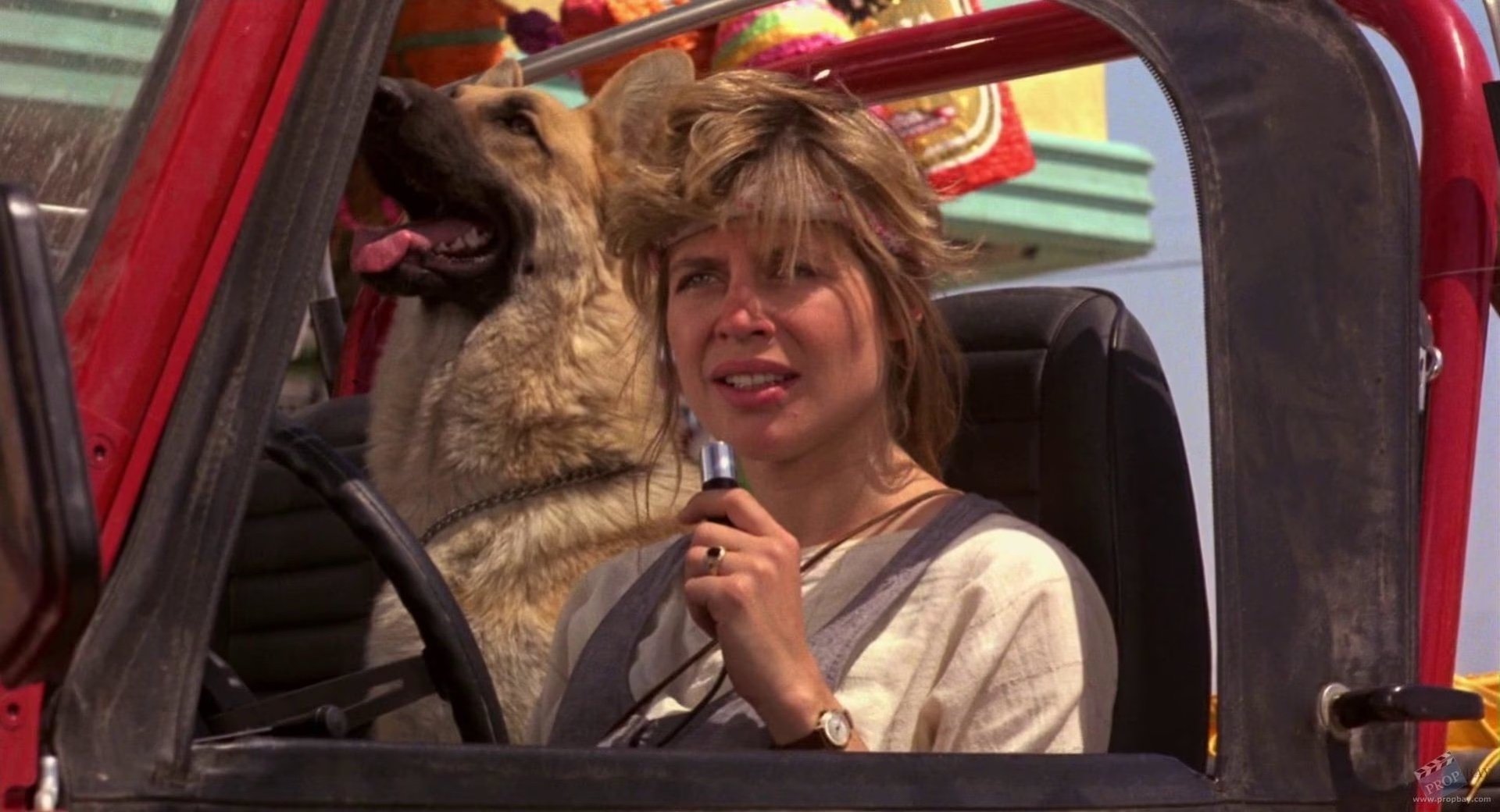 Sarah Connor (Linda Hamilton) sitting next to a dog in a jeep in 'Terminator'