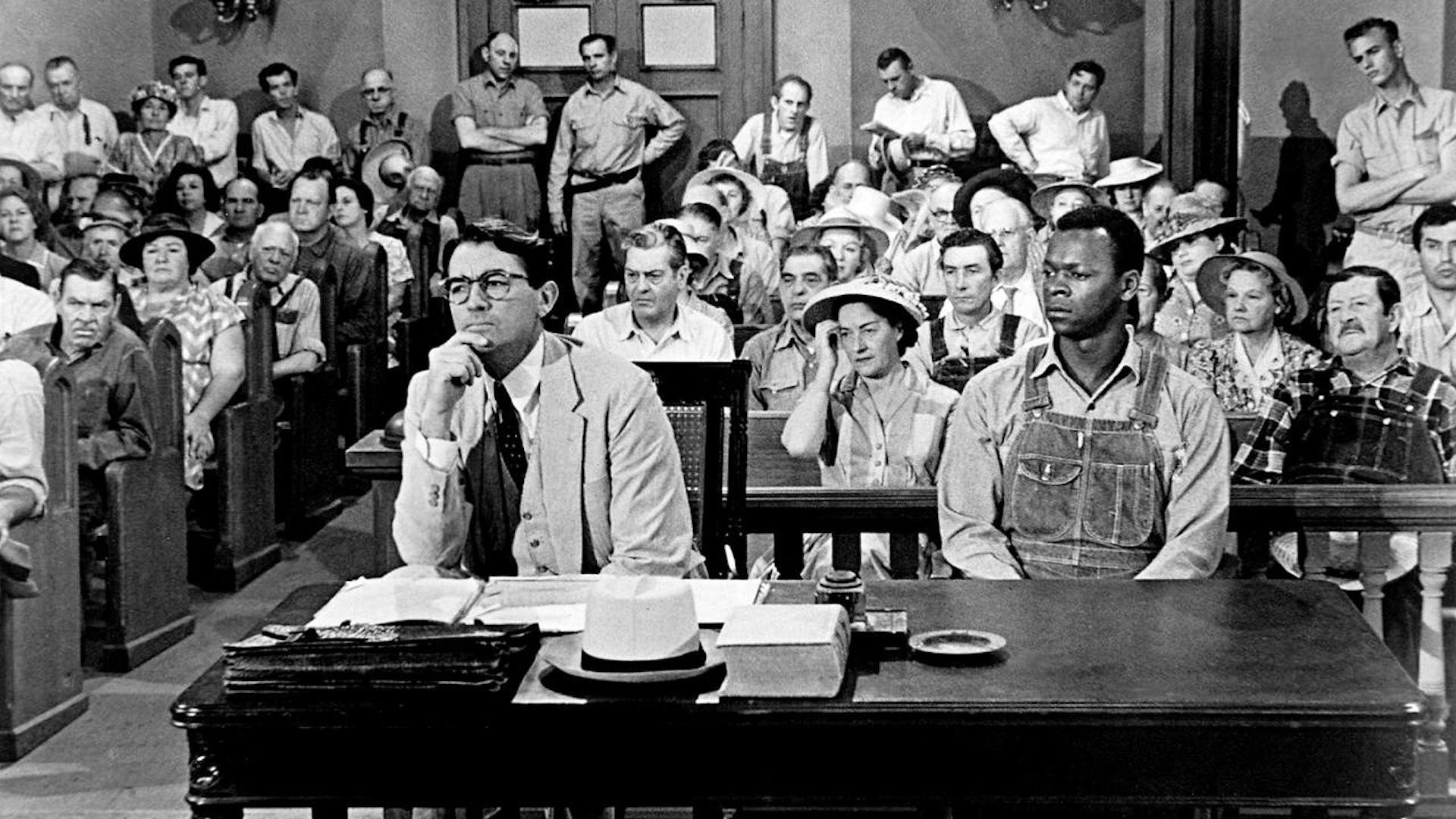 Atticus Finch (Gregory Peck) sitting with Tom (Brock Peters) in a courthouse in 'To Kill a Mockingbird' (1962)